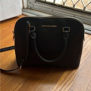 Medium sized black Michael Kors purse.